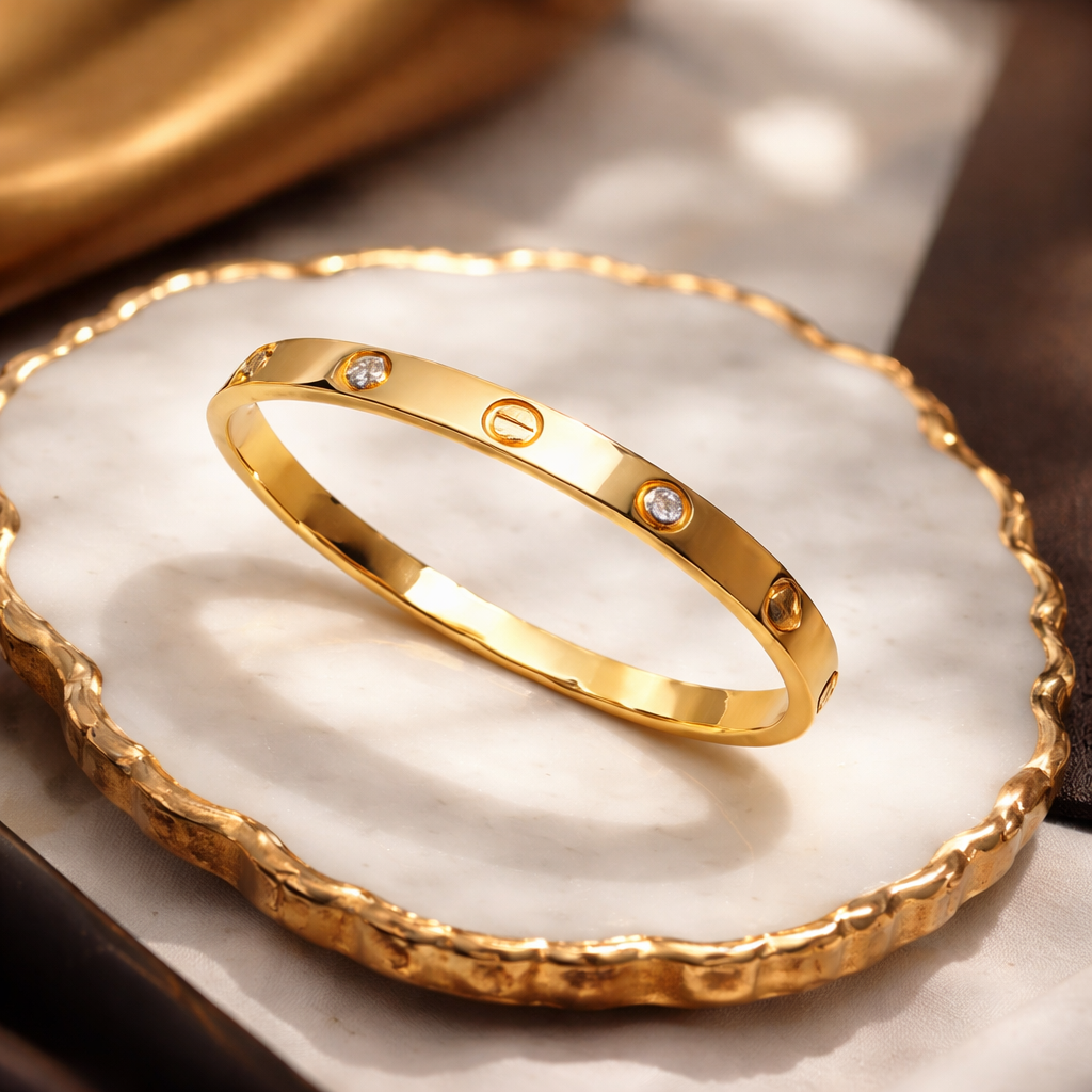 Gold bracelet with diamond accents on a white dish