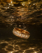 Anti Tarnish Tennis ring with diamonds submerged in water on a reflective surface