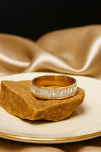 Anti Tarnish ring with diamonds on a rock against a satin background