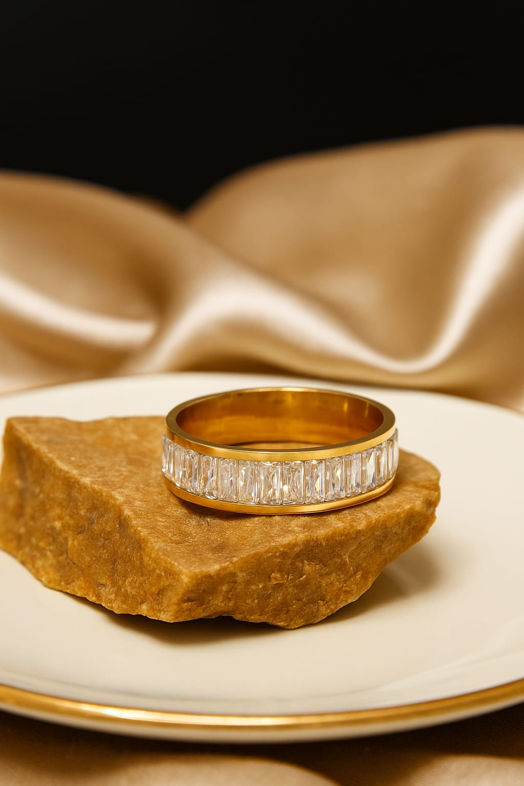 Anti Tarnish ring with diamonds on a rock against a satin background