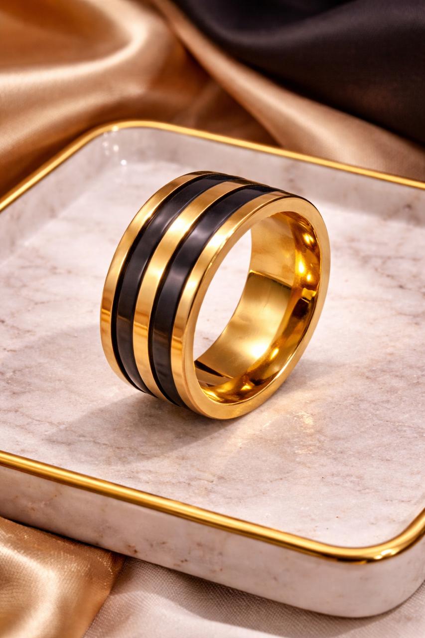 Gold and black ring on a marble surface with gold trim