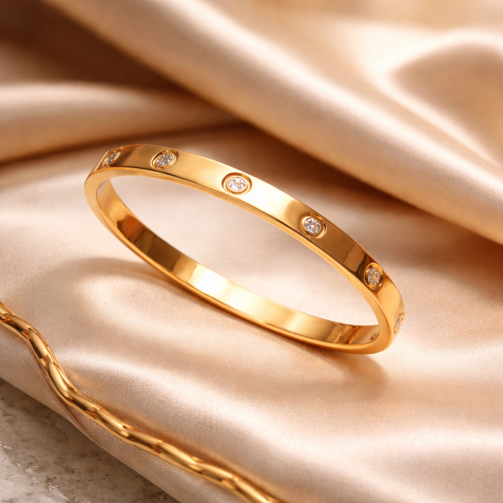 Gold bracelet with small diamonds on a beige fabric background