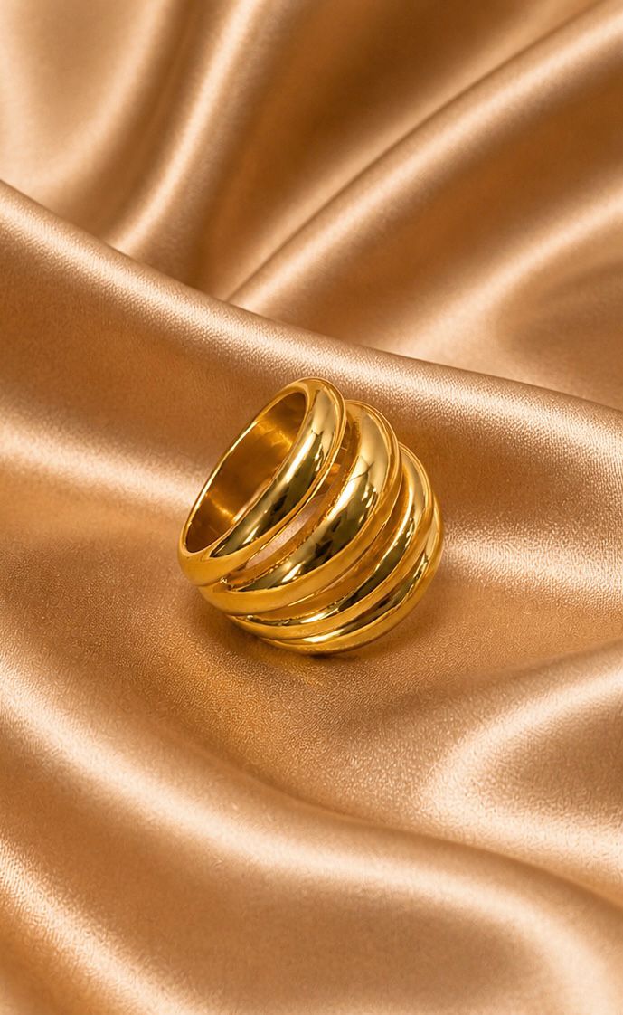 Gold ring on a textured gold fabric background - Quadra Finger Ring