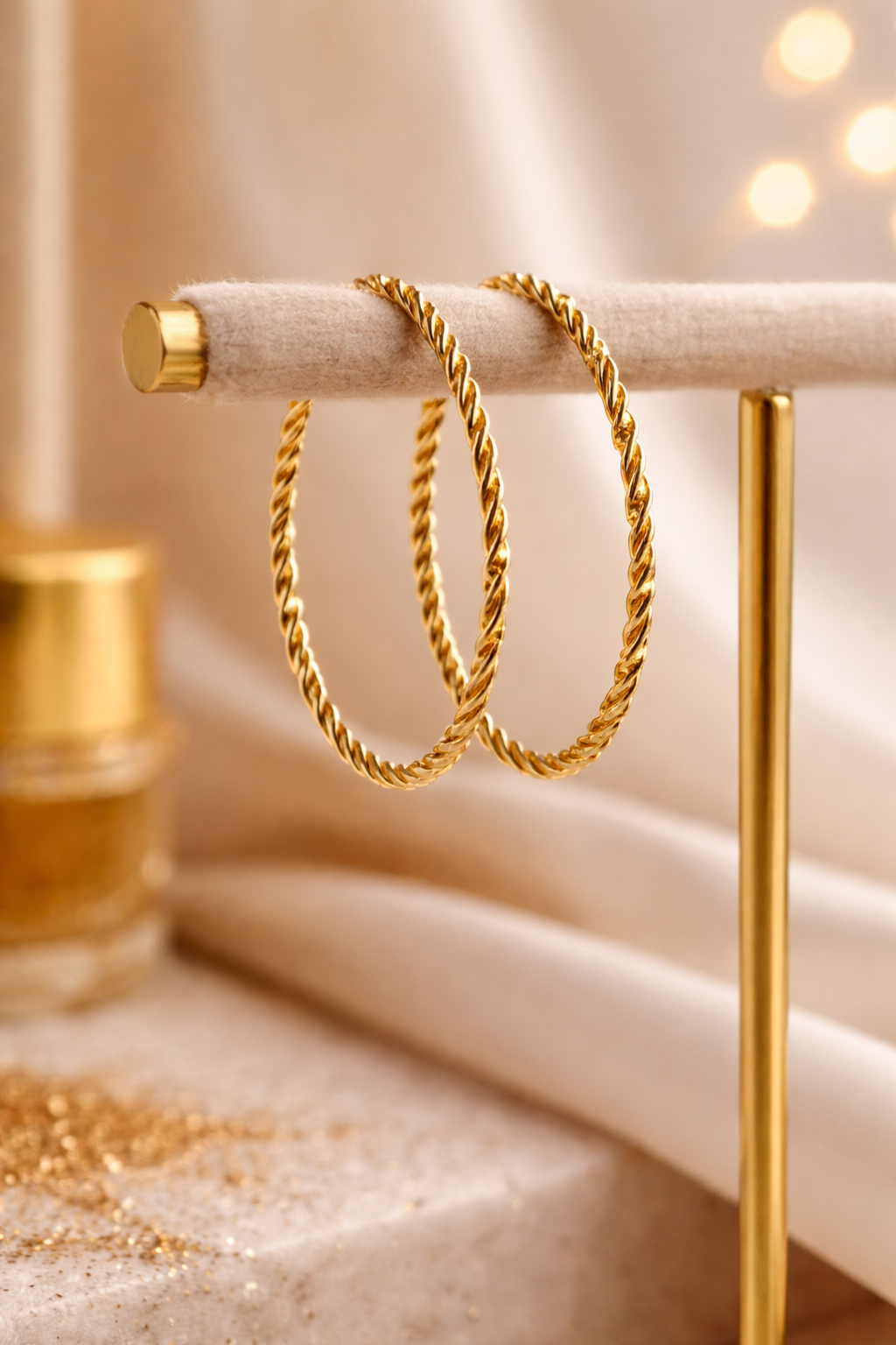 Golden Rope Style Bangle on a decorative stand with a soft, warm background