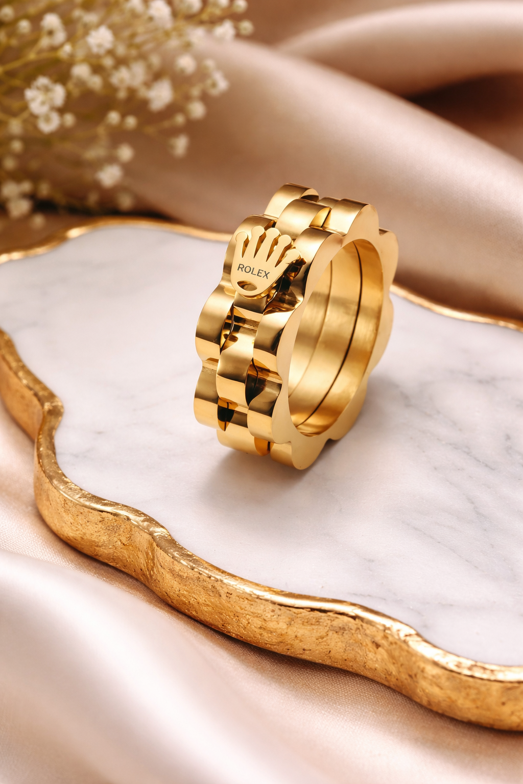Golden ring on a marble surface with a soft background