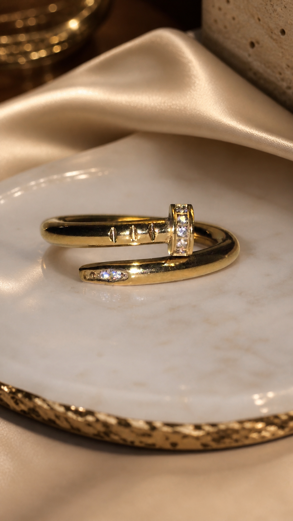 Nail ring with diamonds on a marble surface