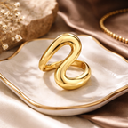 Gold ring on a white dish with a neutral background