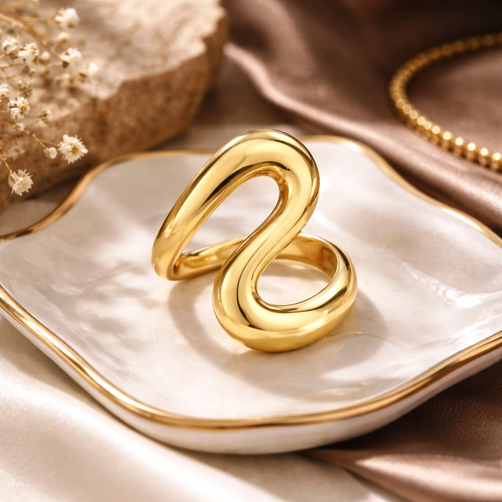 Gold ring on a white dish with a neutral background